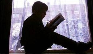 child reading on windowsill 300x176